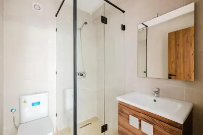 a bathroom with a toilet and a sink and a shower at Modern Studio with Pool in Marrakech