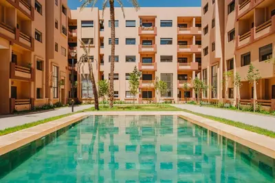 a swimming pool in the courtyard of a building at Modern Studio with Pool in Marrakech