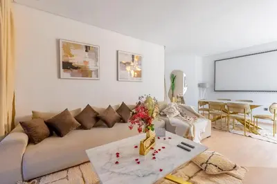 a living room with a couch and a table at Luxury apartment in Prestigia Opale in Marrakech