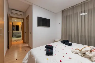 a bedroom with a bed with flowers on it at Luxury apartment in Prestigia Opale in Marrakech