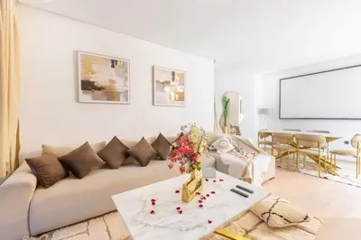 a living room with a couch and a table at Luxury apartment in Prestigia Opale in Marrakech