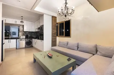 a living room with a couch and a table at Luxury apartment in Prestigia Opale in Marrakech