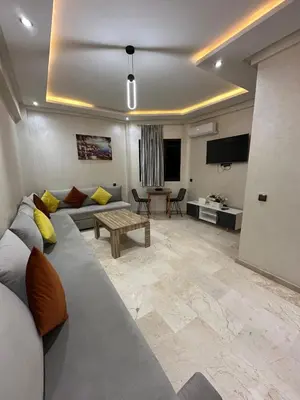 a living room with a couch and a table at 3wina immobilier in Marrakech