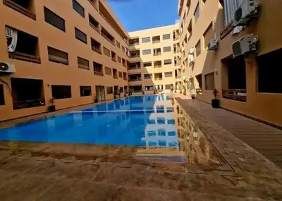 a swimming pool in the middle of a building at 3wina immobilier in Marrakech