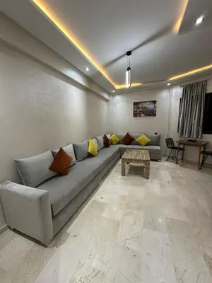 a living room with a couch and a table at 3wina immobilier in Marrakech