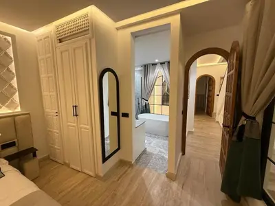 a bedroom with a bathroom with a tub and a mirror at Riad Dar Ninoun, Bassin chauffé & Petits déjeuners in Marrakech