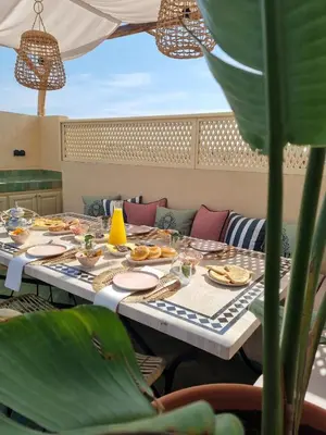 a table with plates of food on it at Riad Dar Ninoun, Bassin chauffé & Petits déjeuners in Marrakech