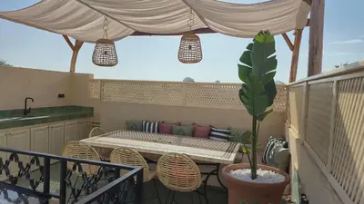 a patio with a table and chairs and a tent at Riad Dar Ninoun, Bassin chauffé & Petits déjeuners in Marrakech