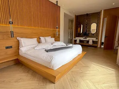 a bedroom with a large bed with white sheets at Palais Oyena in Marrakech