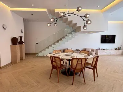 a dining room with a table and a staircase at Palais Oyena in Marrakech