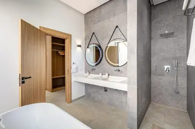 a bathroom with a sink and a mirror at Spacious villa with jacuzzi and activities in Marrakech