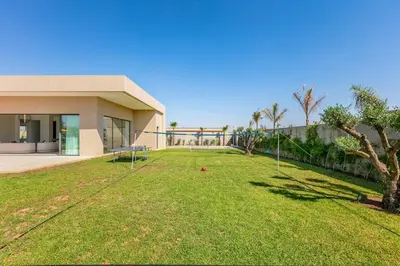 a large yard in front of a house at Spacious villa with jacuzzi and activities in Marrakech