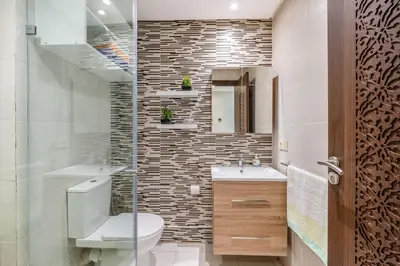 a bathroom with a toilet and a sink and a mirror at Luxe City Escape 2BR Pool in Marrakech