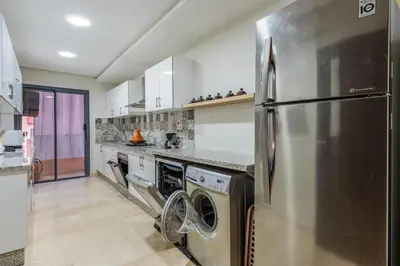 a kitchen with a stainless steel refrigerator and appliances at Luxe City Escape 2BR Pool in Marrakech