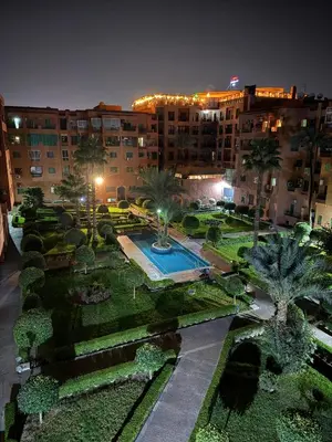 an aerial view of a park with a fountain and a building at 2 BR APP Gueliz Pool Ac Wifi in Marrakech