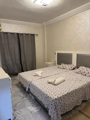 a bedroom with a bed with two pillows on it at 2 BR APP Gueliz Pool Ac Wifi in Marrakech