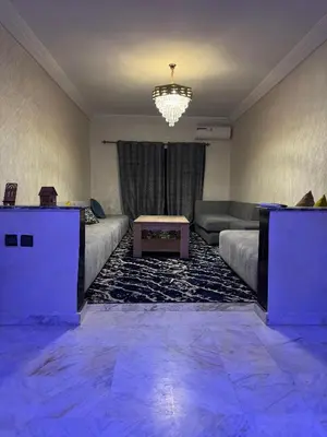 a living room with a couch and a table at 2 BR APP Gueliz Pool Ac Wifi in Marrakech