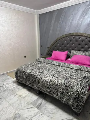 a bedroom with a large bed with pink pillows at 2 BR APP Gueliz Pool Ac Wifi in Marrakech