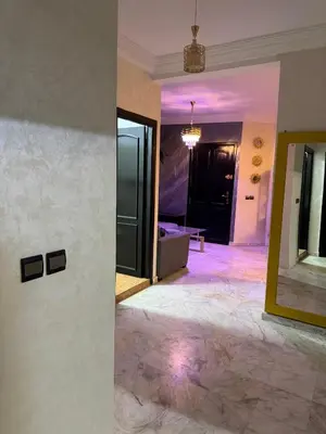 a hallway with a mirror and a room with a couch at 2 BR APP Gueliz Pool Ac Wifi in Marrakech