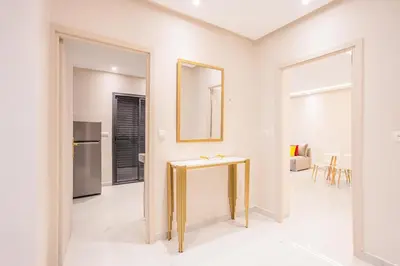 a living room with a gold table in the middle at Cosy & Modern Apartment Near Jardin Majorelle, Marrakech in Marrakech