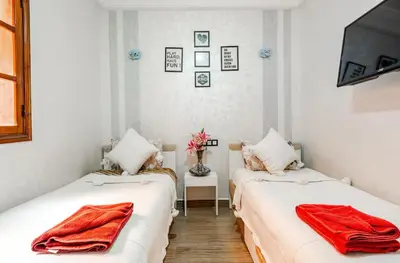 two beds in a room with red towels on them at Princess in Marrakech