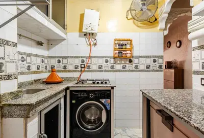 a kitchen with a washing machine and a sink at Princess in Marrakech