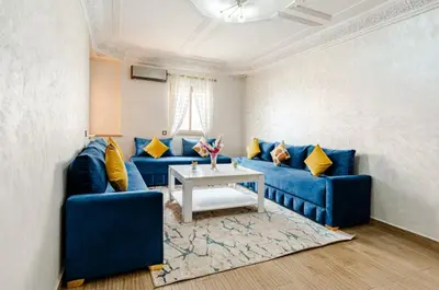 a living room with blue couches and a table at Princess in Marrakech