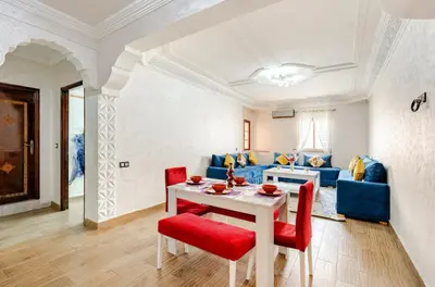 a living room with a table and a blue couch at Princess in Marrakech