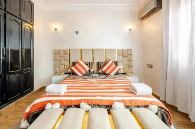 a bedroom with a large bed with two pillows at Princess in Marrakech