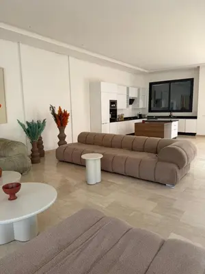 a living room with a large couch and a table at Villa Wissam in Marrakech