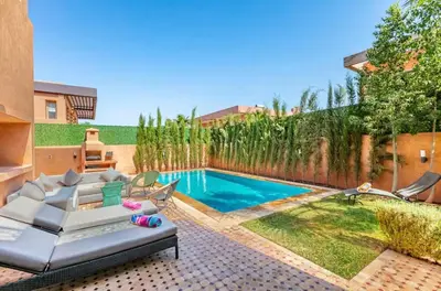a backyard with a swimming pool and a fence at Luxury 4-ROM Villa with private Heated pool in Akenza ,free Airport transport service in El Rhechat