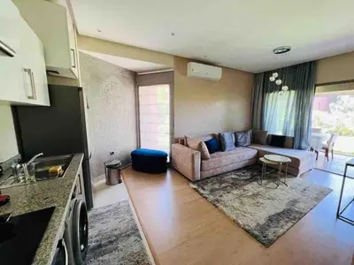 a living room with a couch and a table at Luxury Prestigia Golf City jade in Marrakech