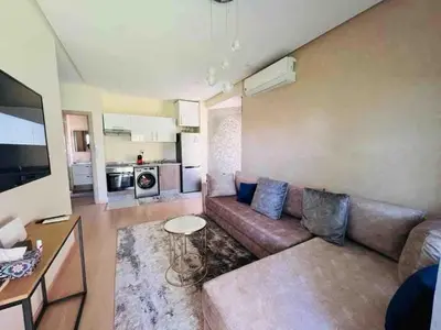 a living room with a couch and a table at Luxury Prestigia Golf City jade in Marrakech