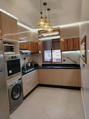 a kitchen with a washing machine and a washer at appartement Jalal in Marrakech