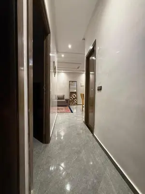 a hallway with a door and a couch in a room at appartement Jalal in Marrakech