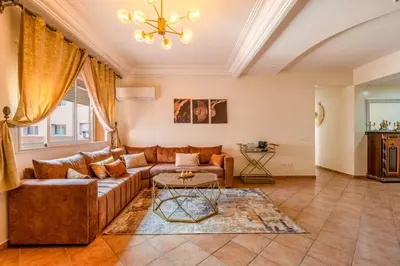 a living room with a couch and a table at Luxury 2BR Apt in Gueliz, Pools, Parking,Elevator in Marrakech