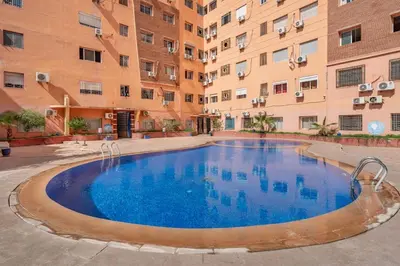 a swimming pool in the courtyard of a building at Luxury 2BR Apt in Gueliz, Pools, Parking,Elevator in Marrakech