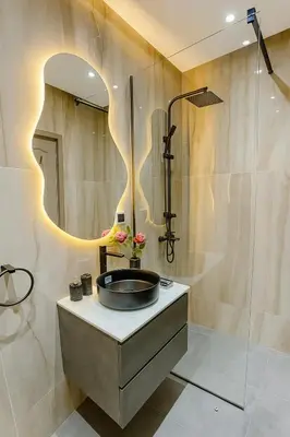 a bathroom with a sink and a mirror at Appartement Confort & Sérénité Mabroka Marrakech in Marrakech