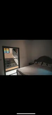 a bedroom with a bed and a view of a balcony at chambres Marrakech in Marrakech