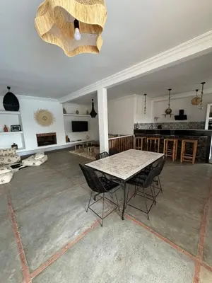 a large living room with a table and chairs at Villa Selma piscine privée sans vis à vis 9 min du centre in Marrakech