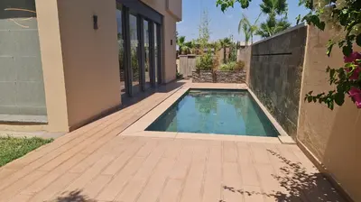 a swimming pool next to a house at Villa Starlight in Marrakech