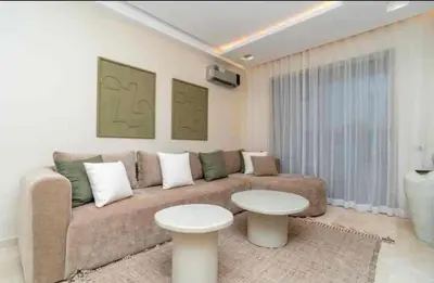 a living room with a couch and a table at Appartement luxe avec vue imprenable sur le golf in Marrakech