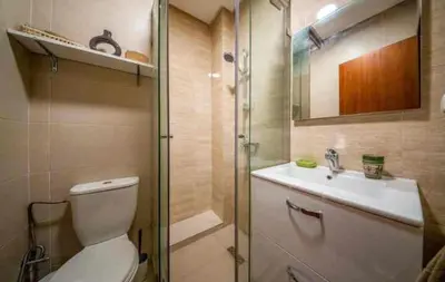 a bathroom with a toilet and a sink and a shower at Appartement luxe avec vue imprenable sur le golf in Marrakech