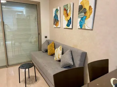 a living room with a gray couch with pillows at studio design prestigia jad in Marrakech