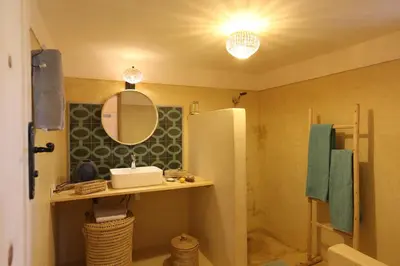 a bathroom with a sink and a mirror at La Vie En Rose - Horses & Dogs House in Marrakech