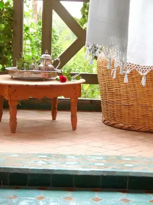 a table with a bowl on it next to a window at La Vie En Rose - Horses & Dogs House in Marrakech