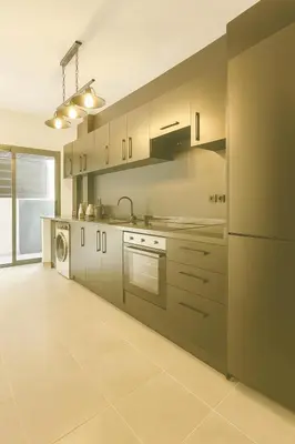 a large kitchen with a stove and a dishwasher at Cozy Appartement avec jacuzzi chauffant in Marrakech