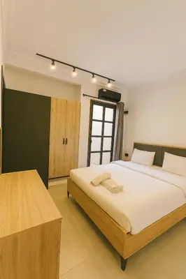 a bedroom with a large bed in a room at Cozy Appartement avec jacuzzi chauffant in Marrakech
