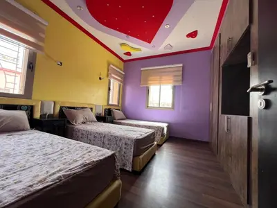a hotel room with two beds and a red ceiling at Villa zinaya in Marrakech