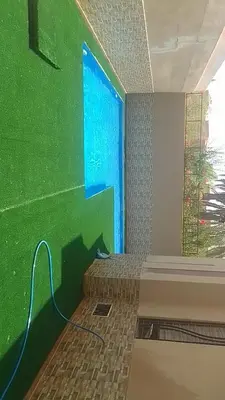 a room with a green wall with a bed in it at Villa zinaya in Marrakech